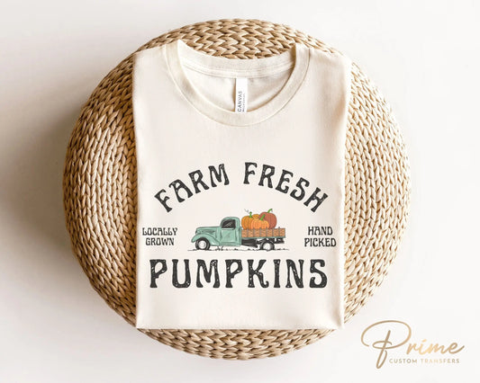 A DTF transfer with the words "Farm Fresh Pumpkins" with a picture of an old vintage truck with pumpkins in the back.