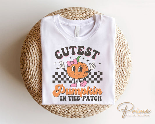 A cold peel direct to film transfer of a cute retro girl pumpkin with the words "Cutest Pumpkin in The Patch" in a curvy font.