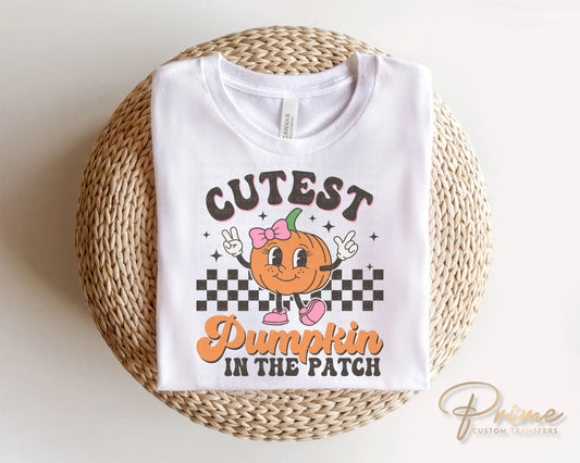 A cold peel direct to film transfer of a cute retro girl pumpkin with the words "Cutest Pumpkin in The Patch" in a curvy font.
