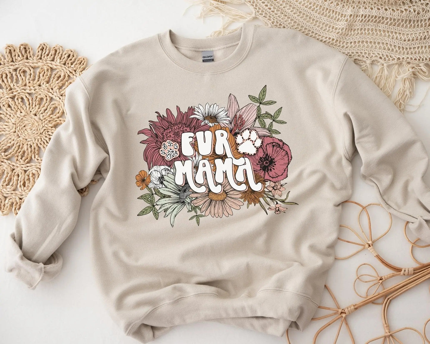 A direct to film transfer that has a floral background with the words Fur Mama overlayed on top. Fur Mama is written in a white colored retro font. The DTF transfer is a cold peel ready to press transfer.
