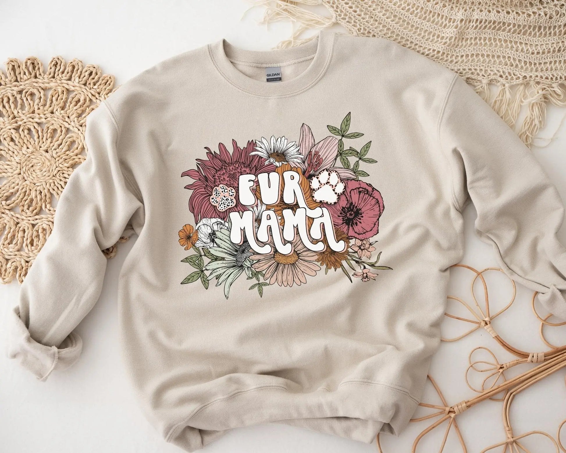 A direct to film transfer that has a floral background with the words Fur Mama overlayed on top. Fur Mama is written in a white colored retro font. The DTF transfer is a cold peel ready to press transfer.