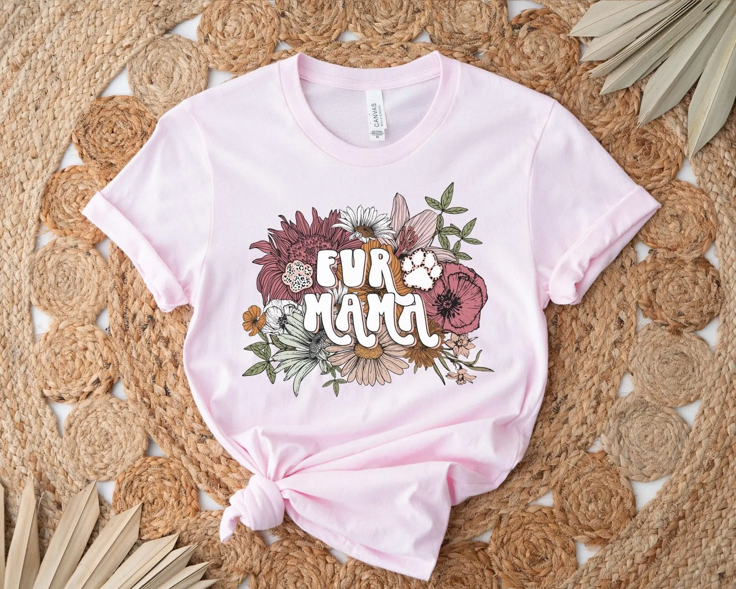 A direct to film transfer that has a floral background with the words Fur Mama overlayed on top. Fur Mama is written in a white colored retro font. The DTF transfer is a cold peel ready to press transfer.