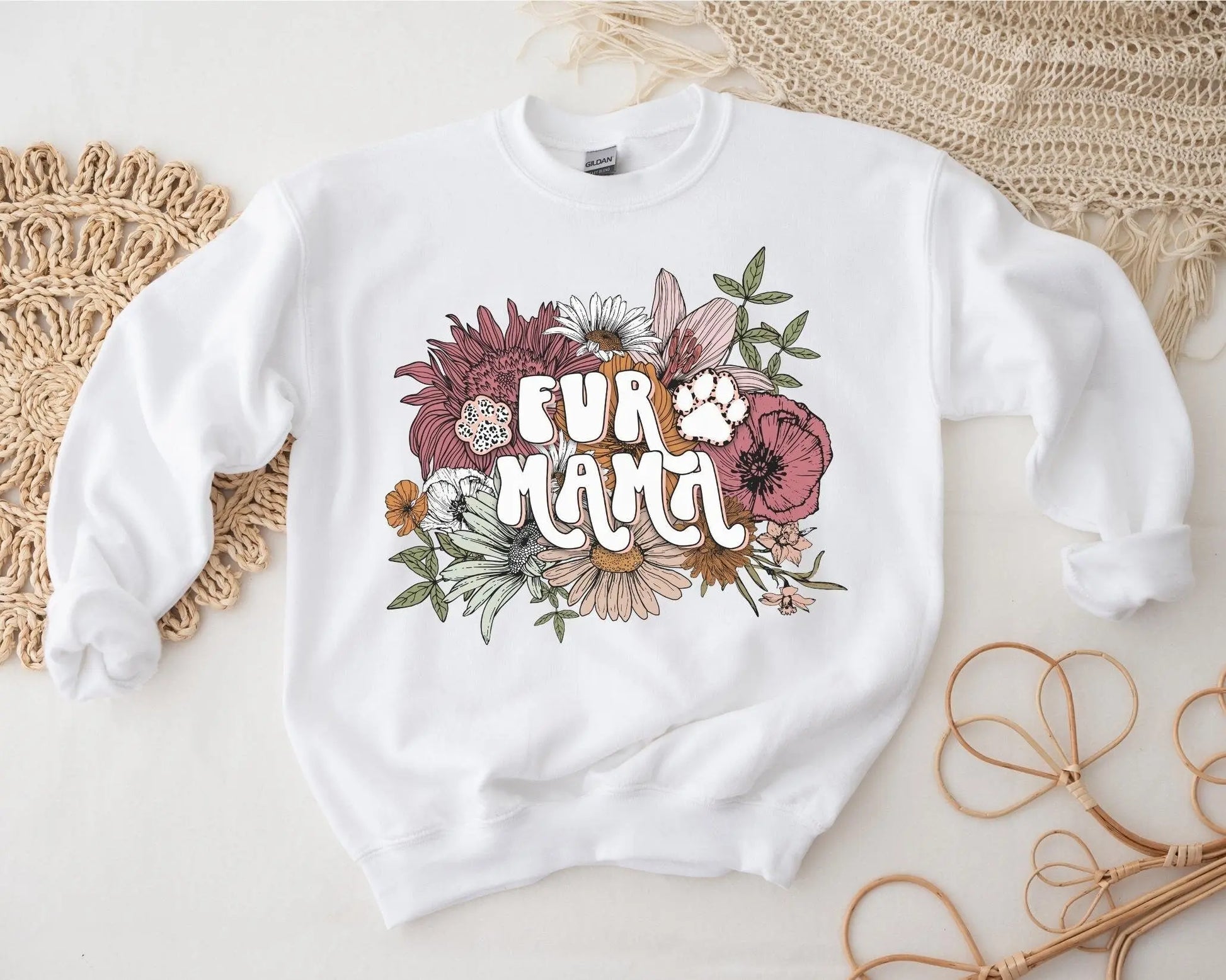 A direct to film transfer that has a floral background with the words Fur Mama overlayed on top. Fur Mama is written in a white colored retro font. The DTF transfer is a cold peel ready to press transfer.