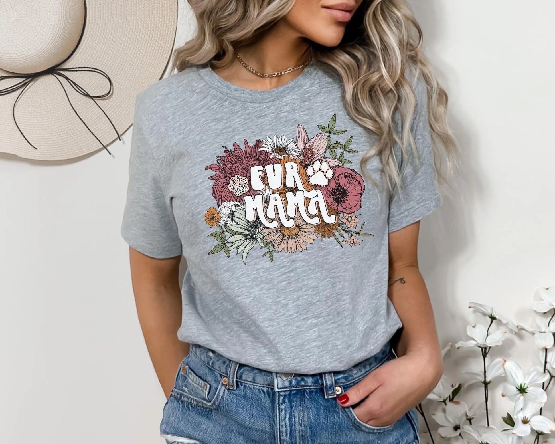 A direct to film transfer that has a floral background with the words Fur Mama overlayed on top. Fur Mama is written in a white colored retro font. The DTF transfer is a cold peel ready to press transfer.
