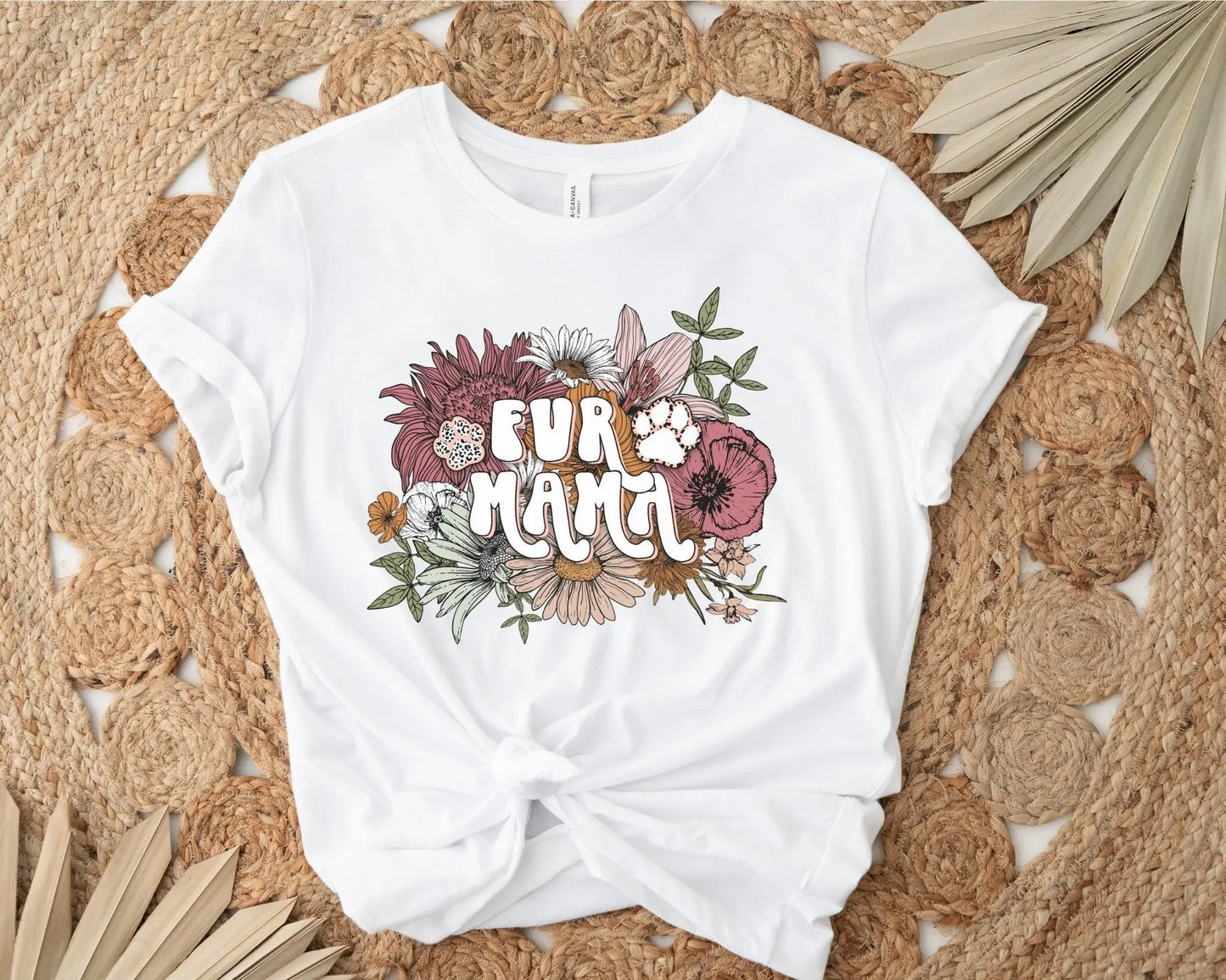 A direct to film transfer that has a floral background with the words Fur Mama overlayed on top. Fur Mama is written in a white colored retro font. The DTF transfer is a cold peel ready to press transfer.