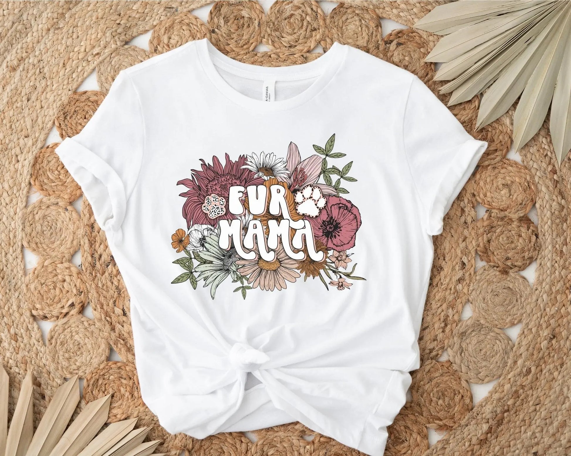 A direct to film transfer that has a floral background with the words Fur Mama overlayed on top. Fur Mama is written in a white colored retro font. The DTF transfer is a cold peel ready to press transfer.