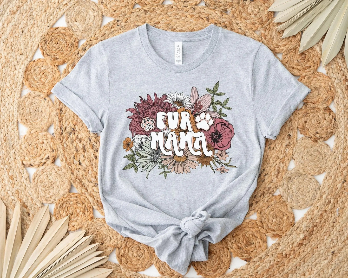 A direct to film transfer that has a floral background with the words Fur Mama overlayed on top. Fur Mama is written in a white colored retro font. The DTF transfer is a cold peel ready to press transfer.