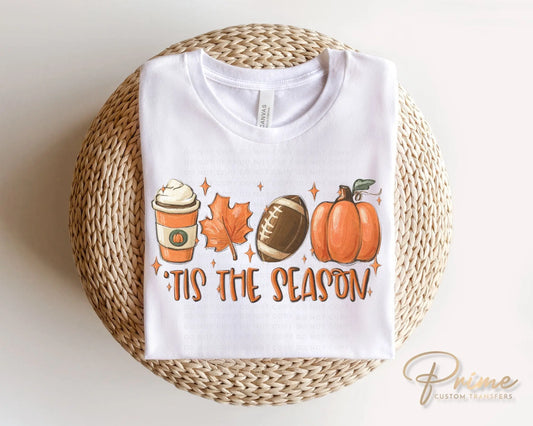 A picture of a white sweatshirt with cute pictures of coffee, leaves, footballs and pumpkins and the words Tis The Season. DTF transfers, DIY , Make your own shirt