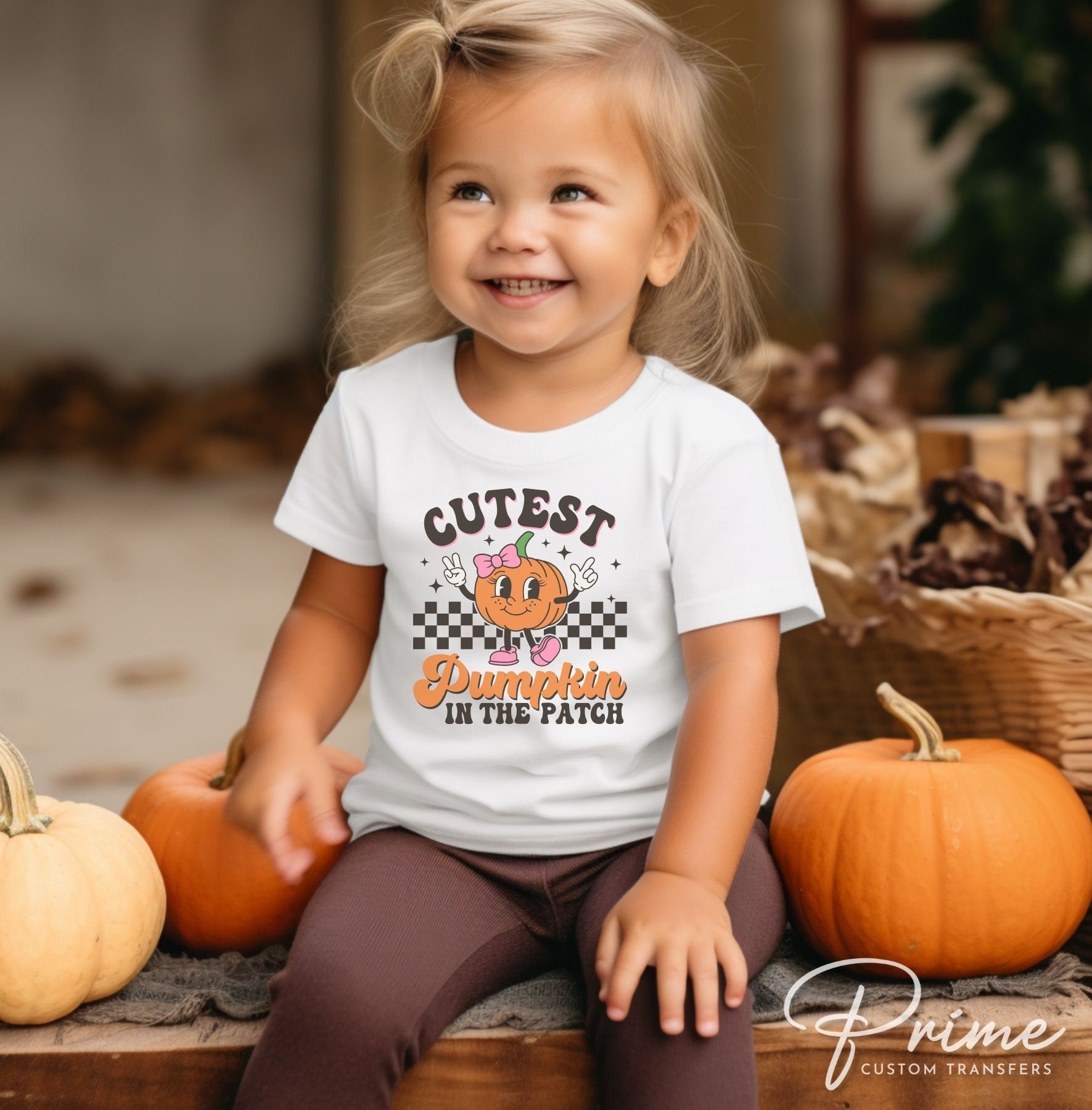 A cold peel direct to film transfer of a cute retro girl pumpkin with the words &quot;Cutest Pumpkin in The Patch&quot; in a curvy font.