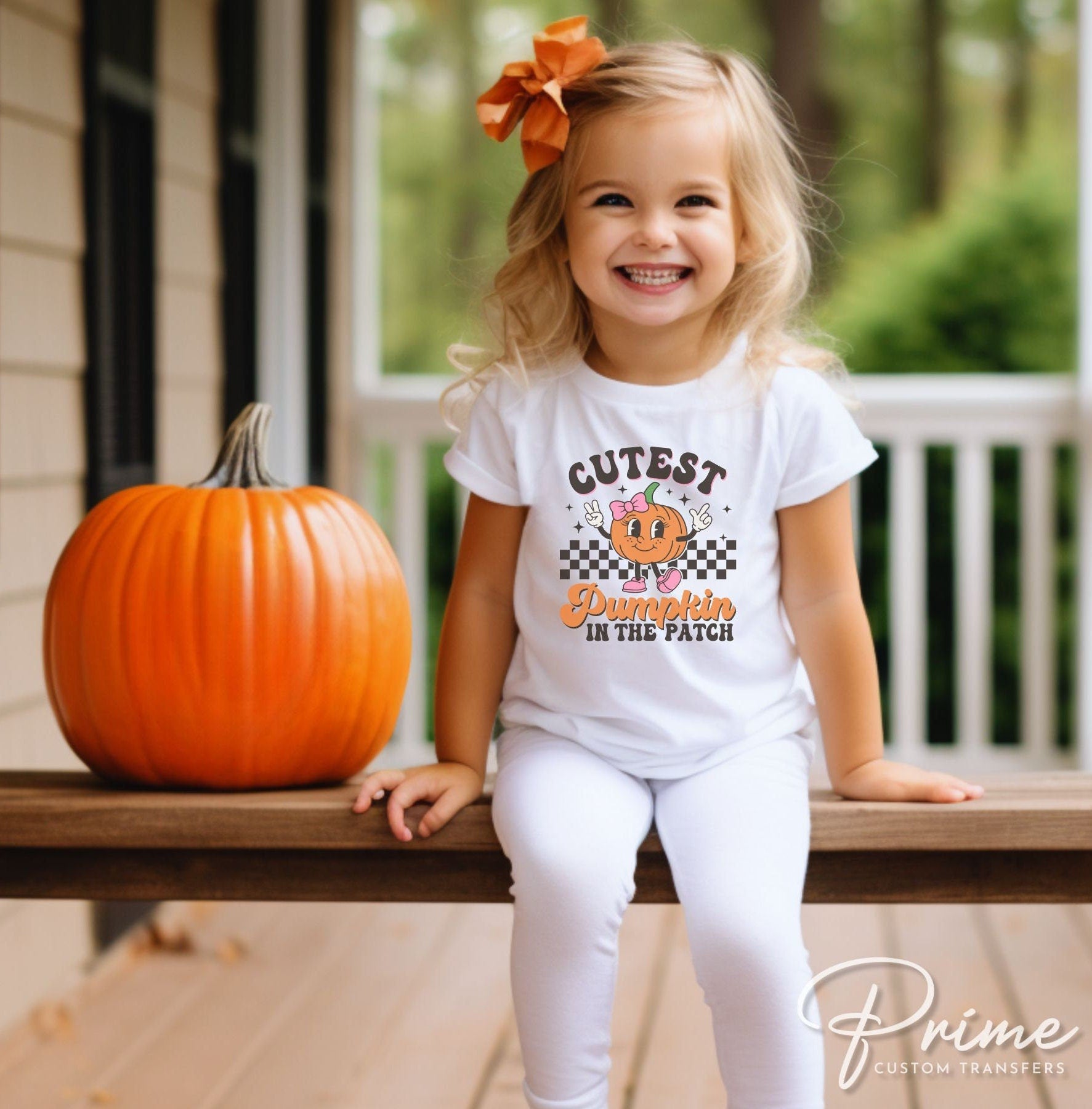 A cold peel direct to film transfer of a cute retro girl pumpkin with the words &quot;Cutest Pumpkin in The Patch&quot; in a curvy font.