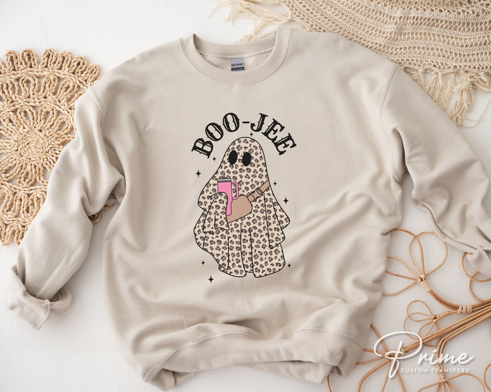 A cold peel direct to film transfer with a leopard patterned ghost holding a tumbler with the words boo-jee above it