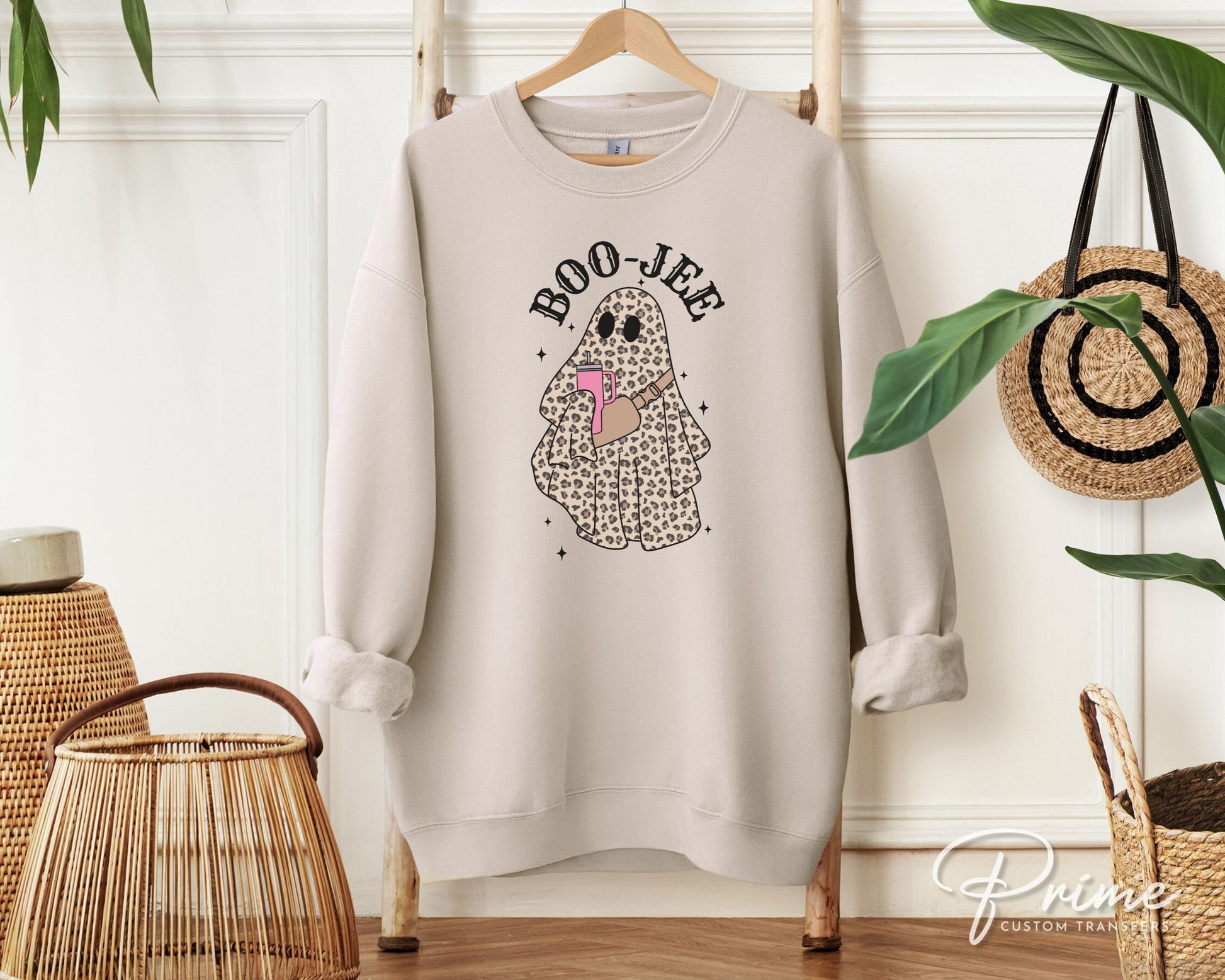 A cold peel direct to film transfer with a leopard patterned ghost holding a tumbler with the words boo-jee above it