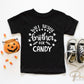 A cold peel halloween direct to film transfer with the saying "Will Trade Brother For Candy" in black or white writing.