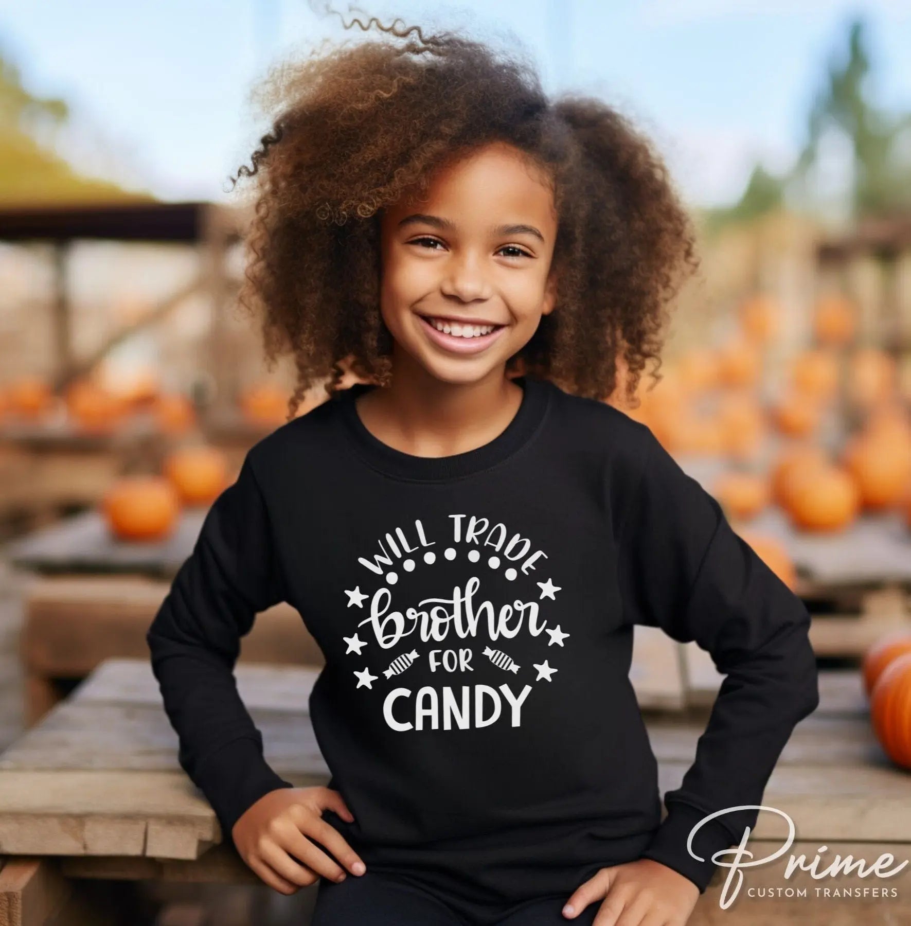 A cold peel halloween direct to film transfer with the saying "Will Trade Brother For Candy" in black or white writing.
